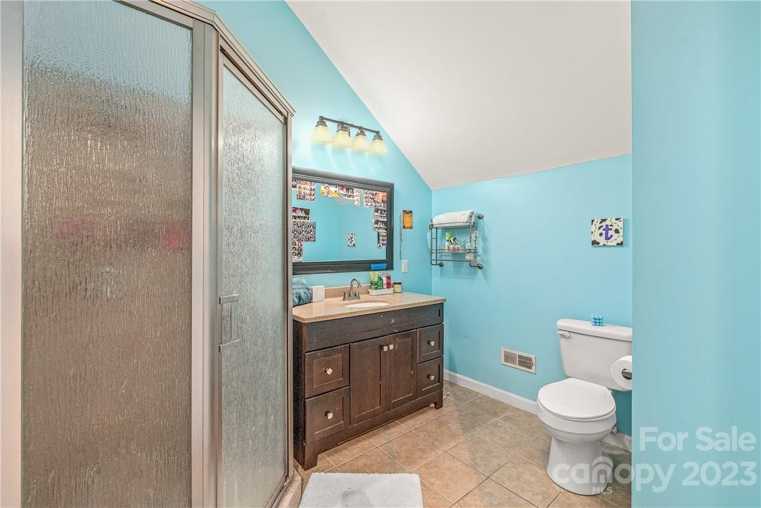 13801 East Rocky River Road Davidson, NC 28036 - Photo 35 of 42 a bathroom with a granite countertop toilet and a sink