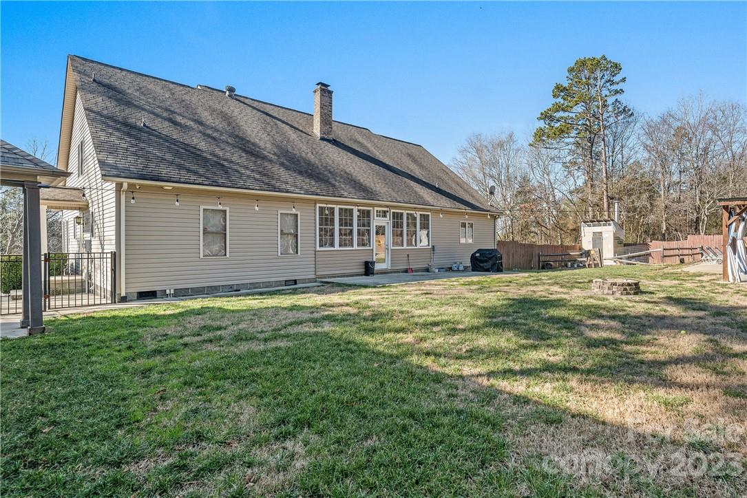 13801 East Rocky River Road Davidson, NC 28036 - Photo 37 of 42 a view of a house with a backyard