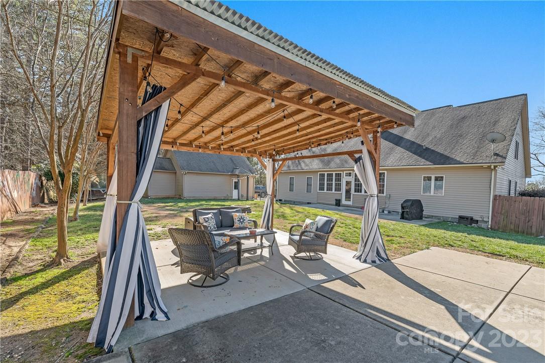 13801 East Rocky River Road Davidson, NC 28036 - Photo 38 of 42 a view of backyard with swimming pool and seating space