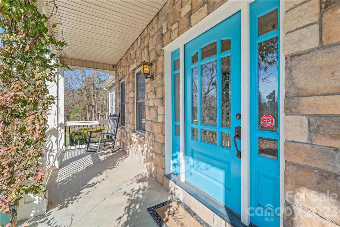 13801 East Rocky River Road Davidson, NC 28036 - Photo 4 of 42 a porch with a table and chairs