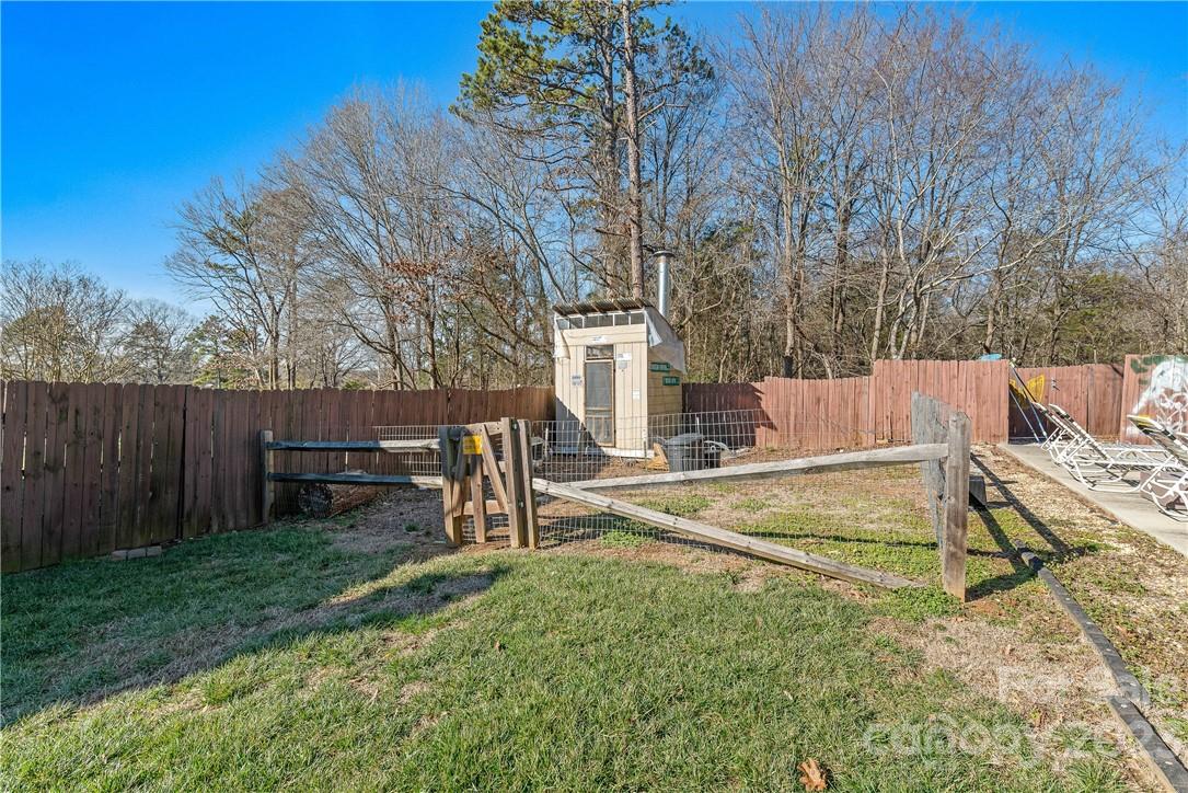 13801 East Rocky River Road Davidson, NC 28036 - Photo 42 of 42 a view of backyard with wooden fence and a large tree