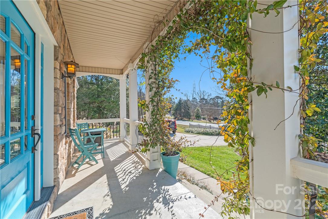 13801 East Rocky River Road Davidson, NC 28036 - Photo 5 of 42 a view of a porch with chairs and potted plants