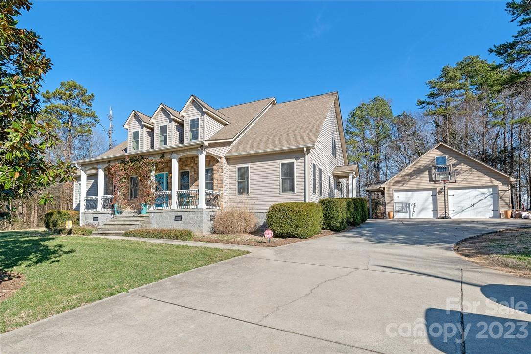 13801 East Rocky River Road Davidson, NC 28036 - Photo 6 of 42 a front view of a house with a yard