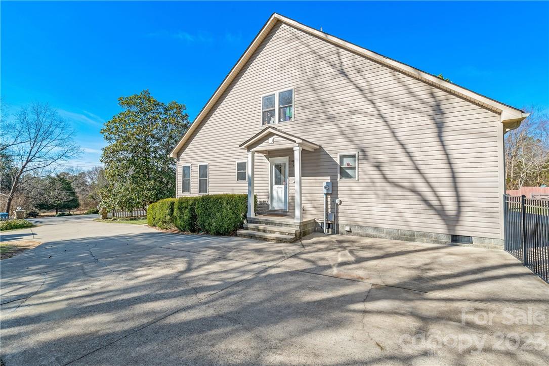13801 East Rocky River Road Davidson, NC 28036 - Photo 9 of 42 a front view of a house with a yard