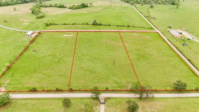 a view of a big yard with lots of green space