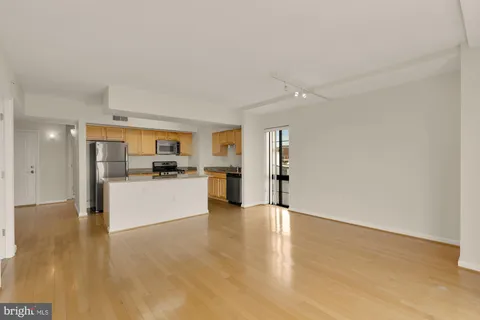 a view of a kitchen with a sink and a refrigerator