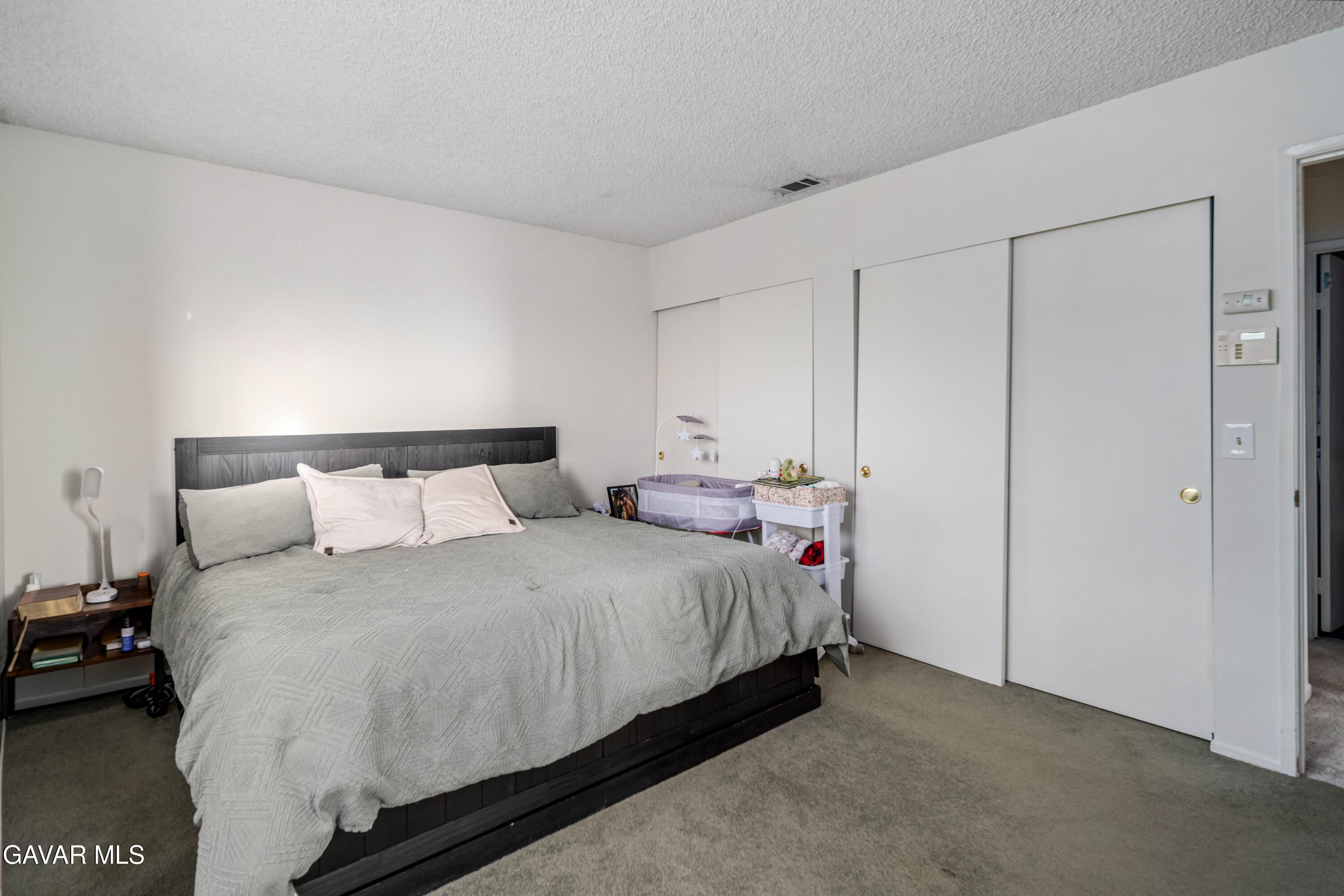 20539 East Ave R Palmdale, CA 93591 - Photo 28 of 55 a bedroom with a bed and a night stand