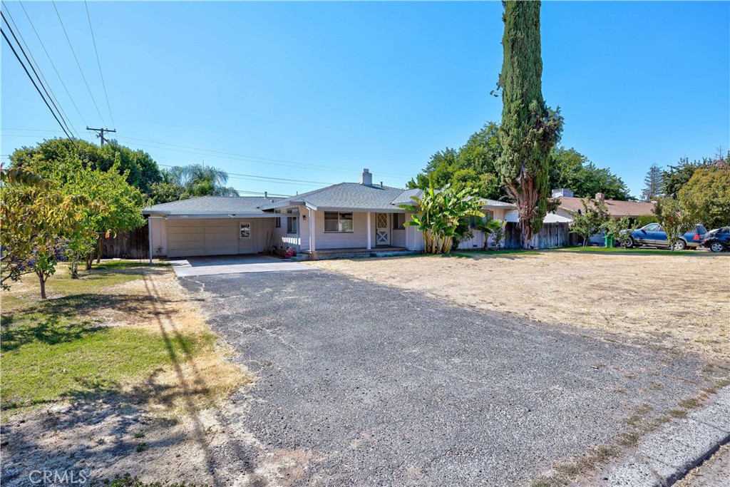 a front view of a house with a yard and potted plants