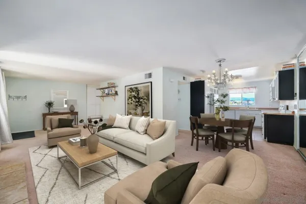 a living room with furniture kitchen view and a flat screen tv