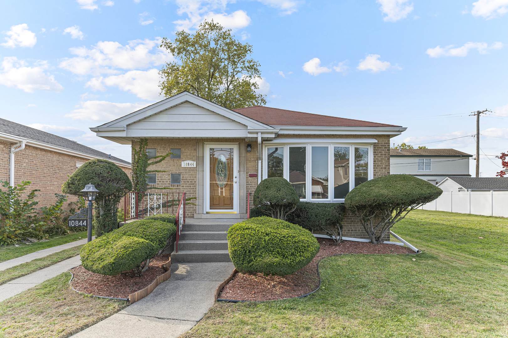 a front view of a house with garden