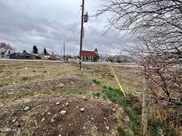 a view of a yard with wooden fence