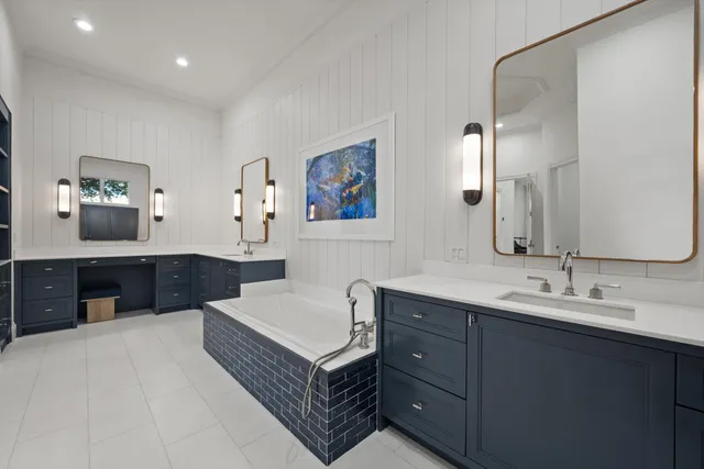 a spacious bathroom with a double vanity sink and a mirror