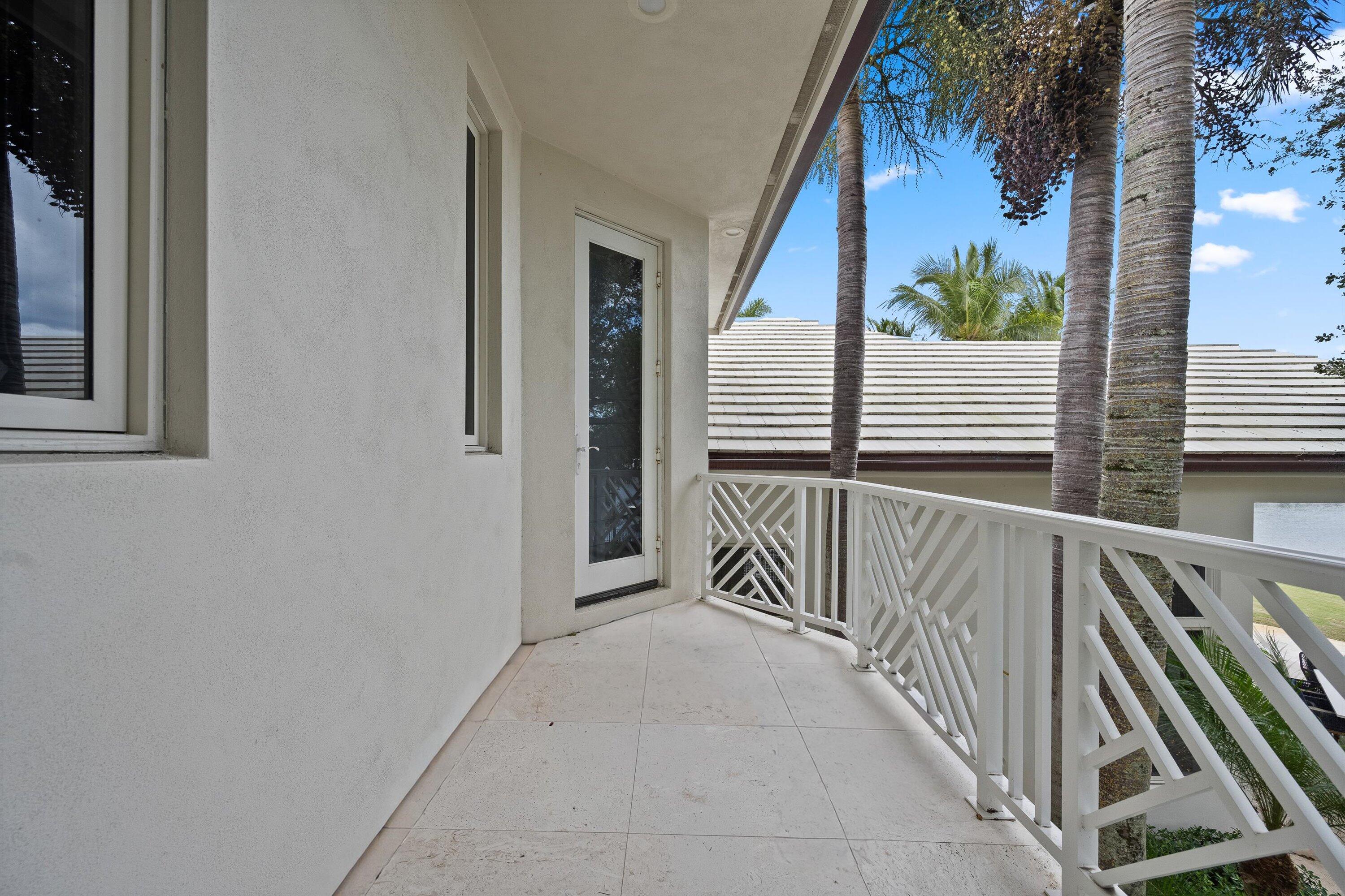 2270 Wilsee Road Palm Beach Gardens, FL 33410 - Photo 23 of 49 a view of a house with stairs and a floor to ceiling window