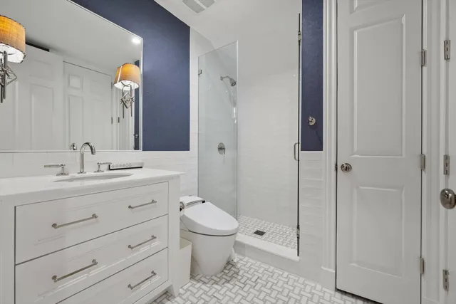 a bathroom with a toilet a sink and shower