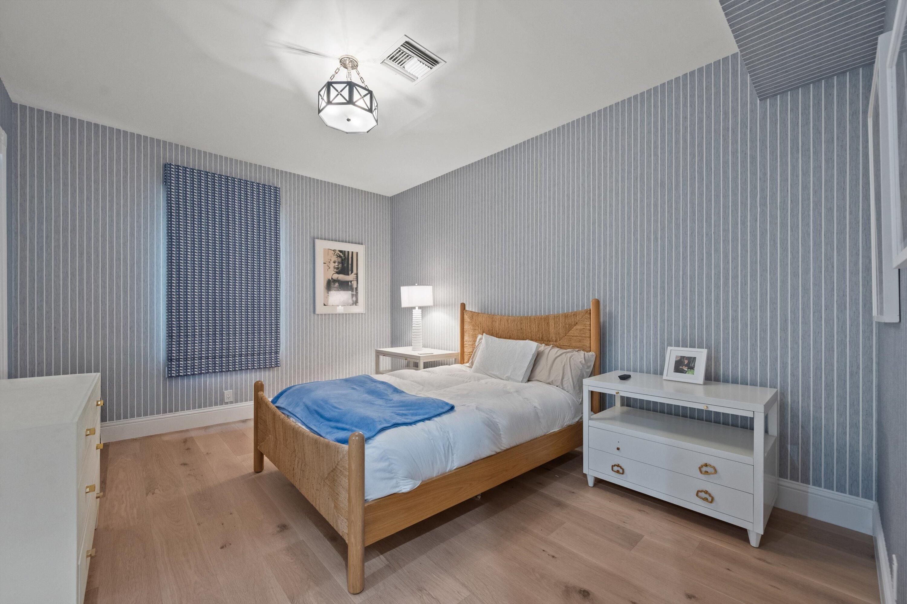 2270 Wilsee Road Palm Beach Gardens, FL 33410 - Photo 25 of 49 a spacious bedroom with a bed and a table