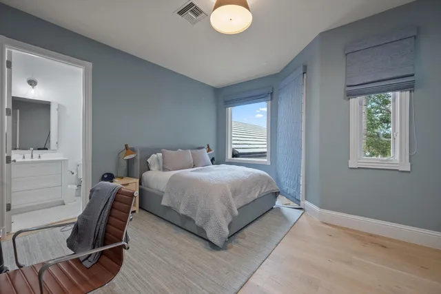 a bedroom with a bed chair and window