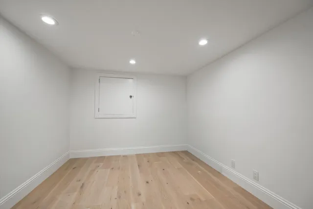 a view of room with wooden floor