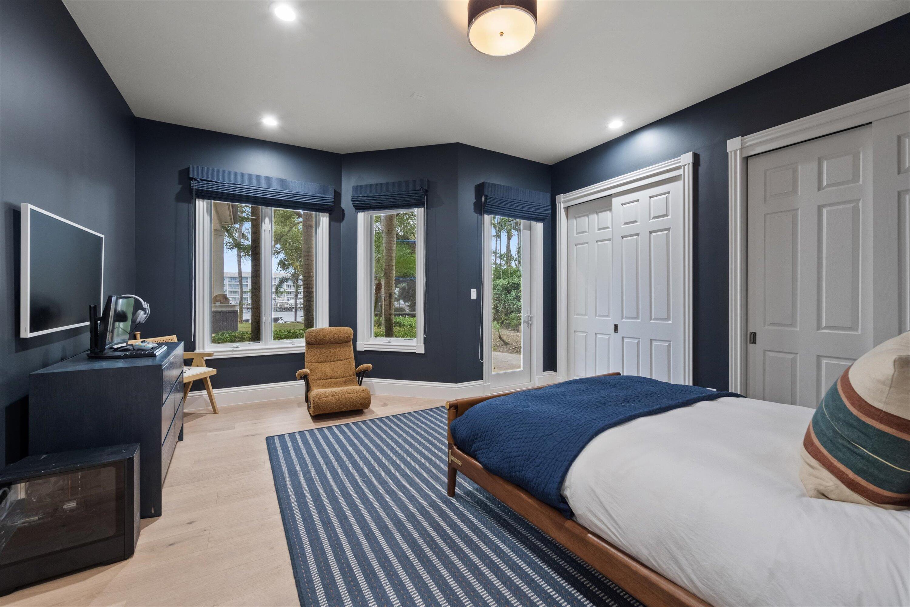 2270 Wilsee Road Palm Beach Gardens, FL 33410 - Photo 30 of 49 a bedroom with a bed and large windows