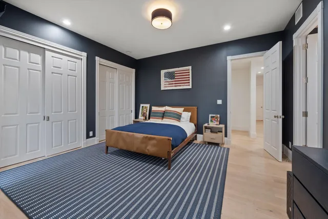 a bedroom with a bed and a night stand