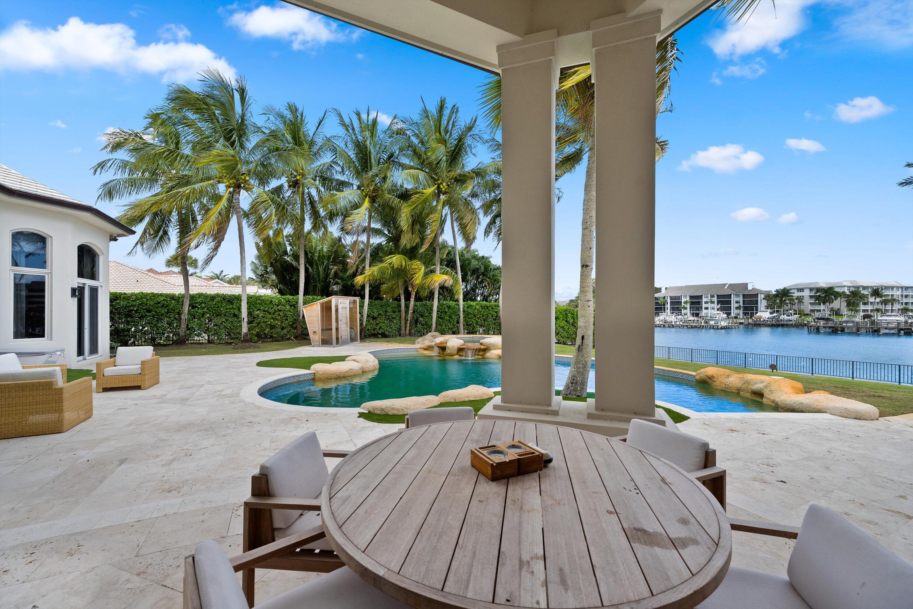 2270 Wilsee Road Palm Beach Gardens, FL 33410 - Photo 35 of 49 a view of a swimming pool with a lounge chairs