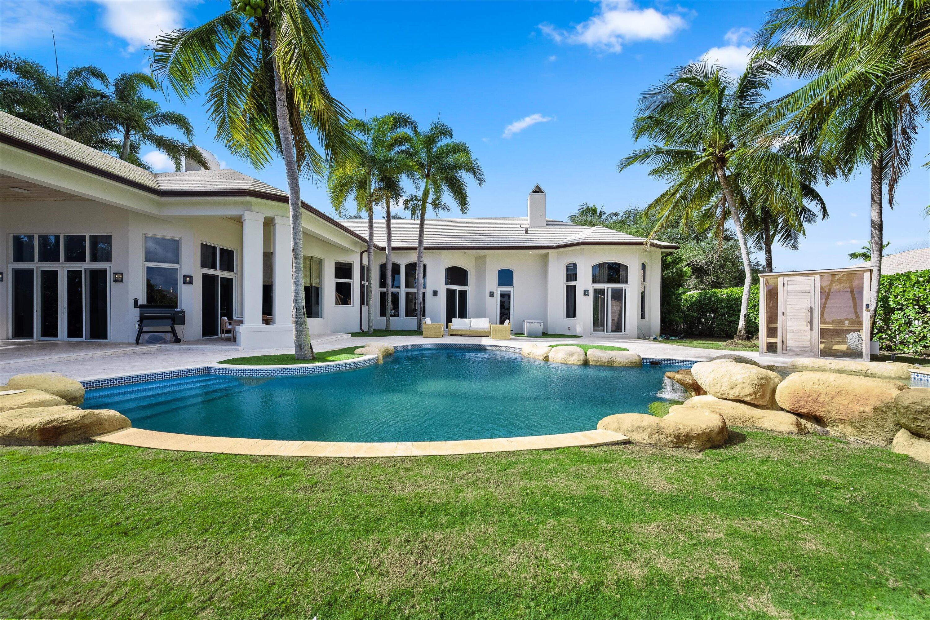 2270 Wilsee Road Palm Beach Gardens, FL 33410 - Photo 39 of 49 a view of house with swimming pool outdoor seating