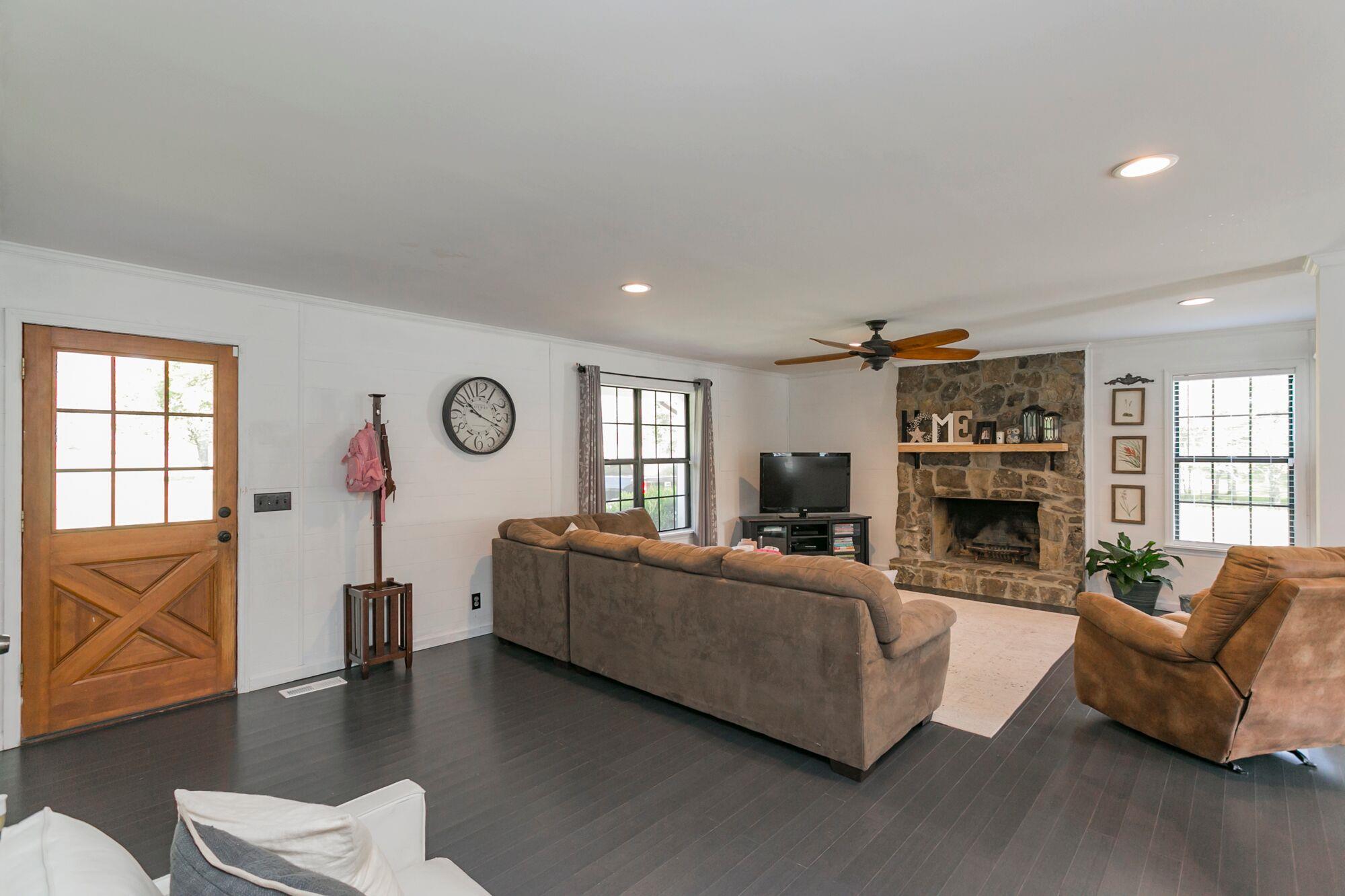 7690 Joe Rowlin Road Christiana, TN 37037 - Photo 2 of 18 a living room with fireplace furniture and a wooden floor