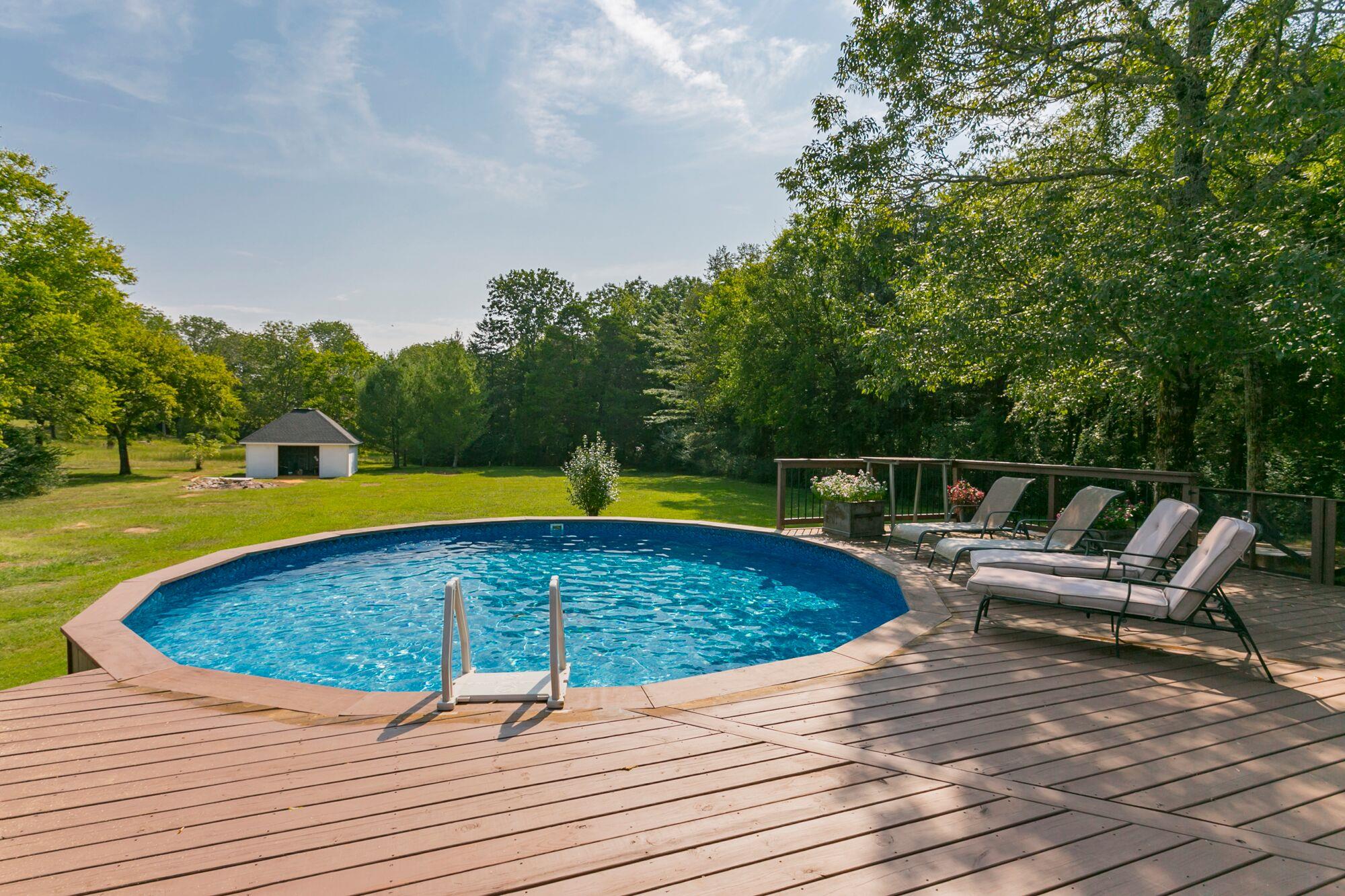 7690 Joe Rowlin Road Christiana, TN 37037 - Photo 16 of 18 a view of a swimming pool with a lounge chair