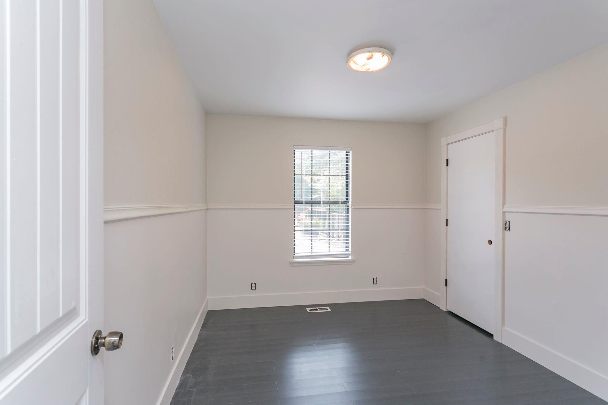 7690 Joe Rowlin Road Christiana, TN 37037 - Photo 8 of 18 an empty room with wooden floor and windows