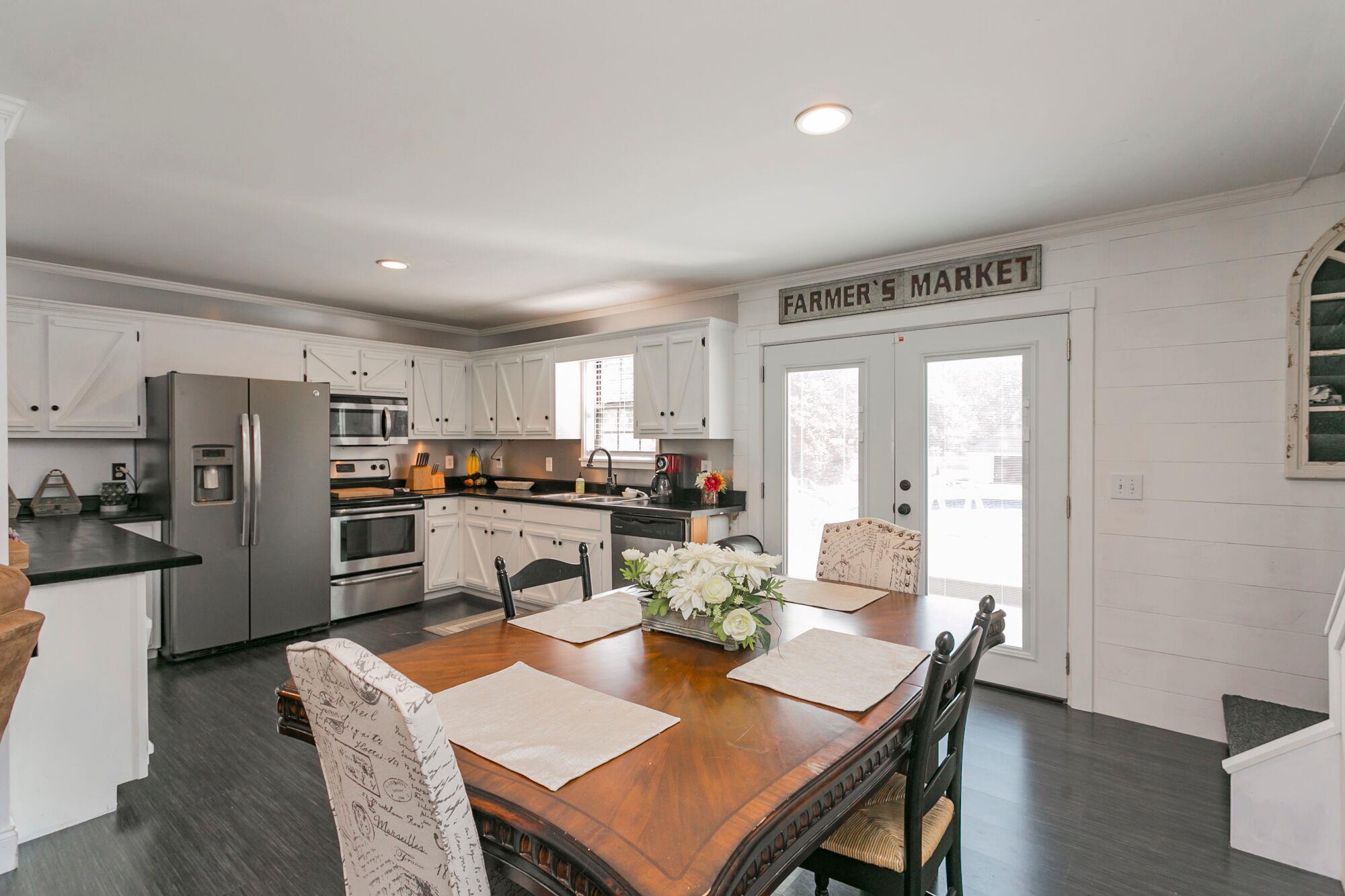 7690 Joe Rowlin Road Christiana, TN 37037 - Photo 10 of 18 a view of a dining room with furniture a kitchen and chandelier