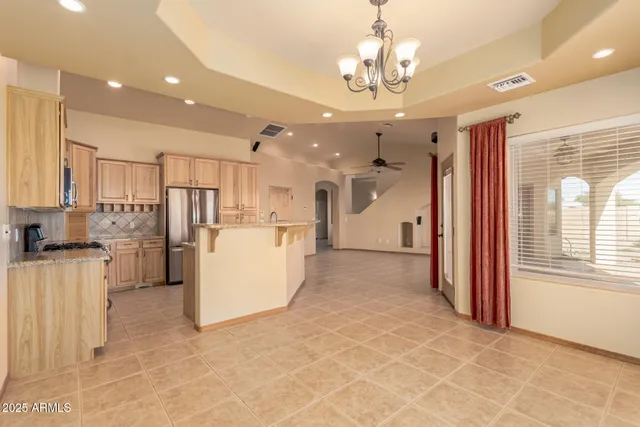 a kitchen with a refrigerator a stove and cabinets