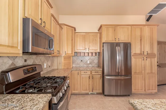 a bathroom with a granite countertop sink and a large mirror