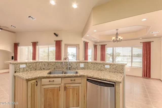 a kitchen with stainless steel appliances granite countertop a sink stove and cabinets