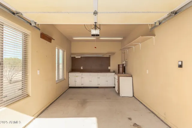 a view of a livingroom with wooden floor and a ceiling fan