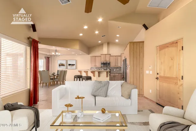 a view of a livingroom with a ceiling fan and window