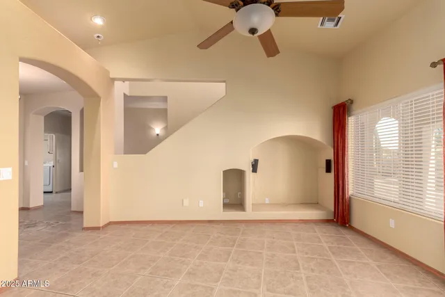 a view of a kitchen with refrigerator and cabinets