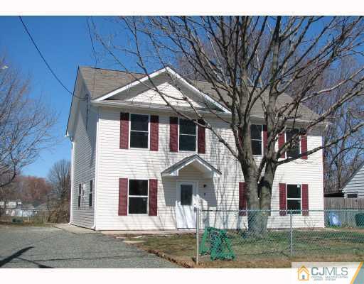 8 Markham Road Edison, NJ 08817 - Photo 1 of 7 a front view of a house with a yard