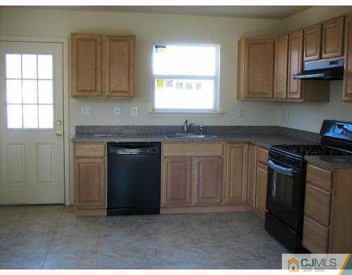 8 Markham Road Edison, NJ 08817 - Photo 2 of 7 a kitchen with stainless steel appliances granite countertop a stove a sink and a microwave