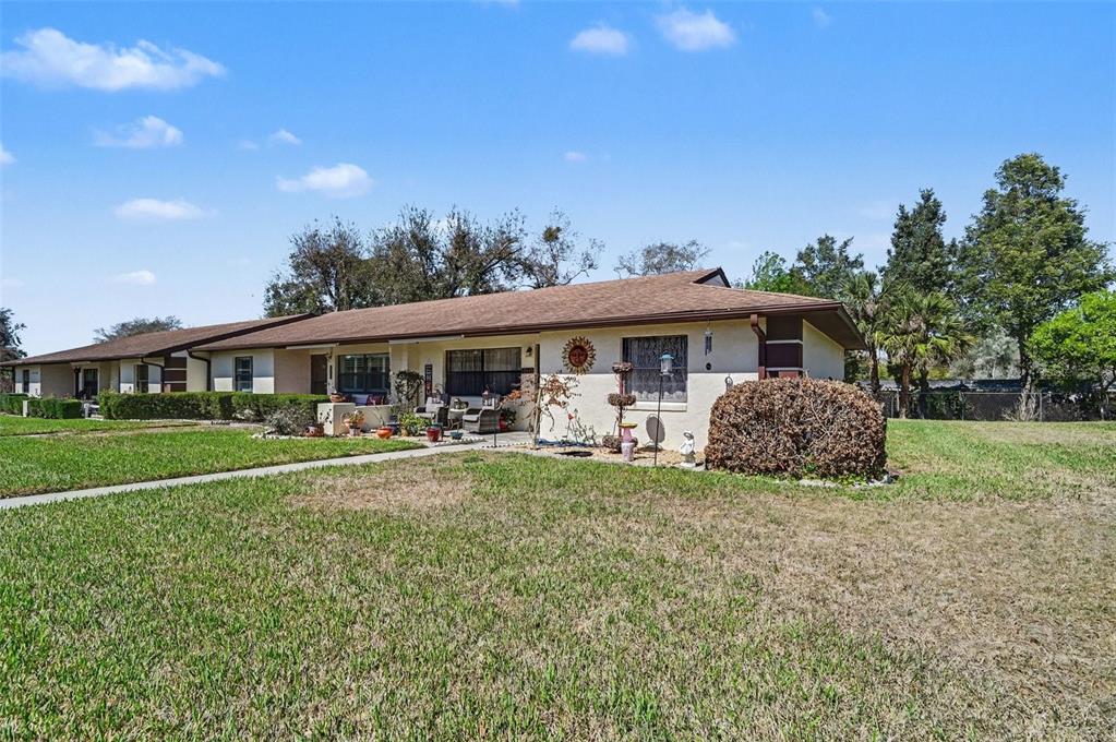 12435 Orangewood Circle Tavares, FL 32778 - Photo 2 of 30 a front view of a house with swimming pool having outdoor seating