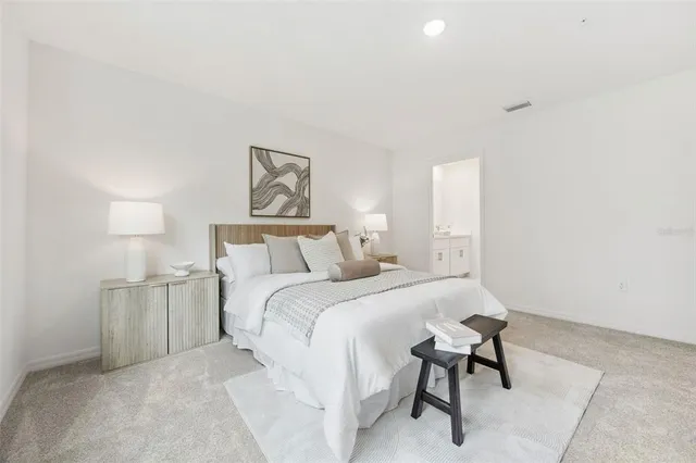 a bedroom with a bed and a large window