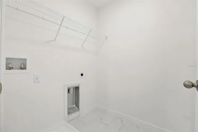 a view of a white house with large windows and a yard