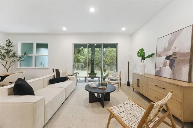 a living room with furniture and a large window