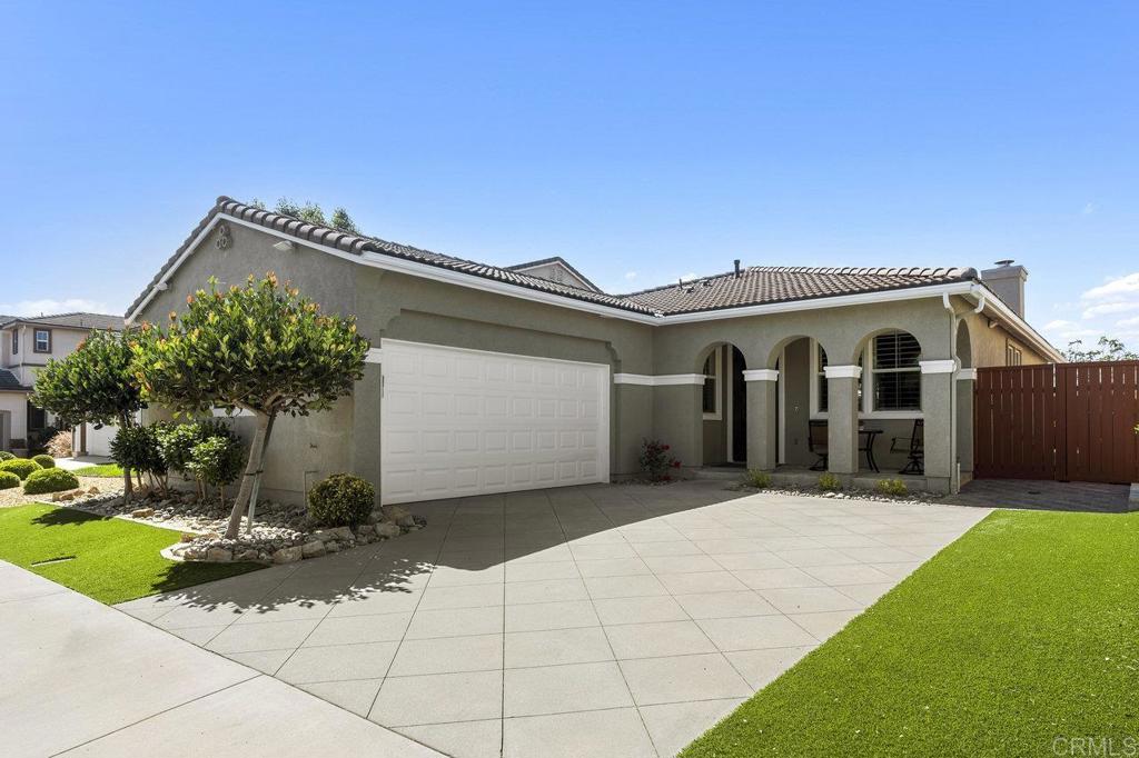 1113 Teal Way Oceanside, CA 92057 - Photo 1 of 49 a front view of a house with a yard and potted plants