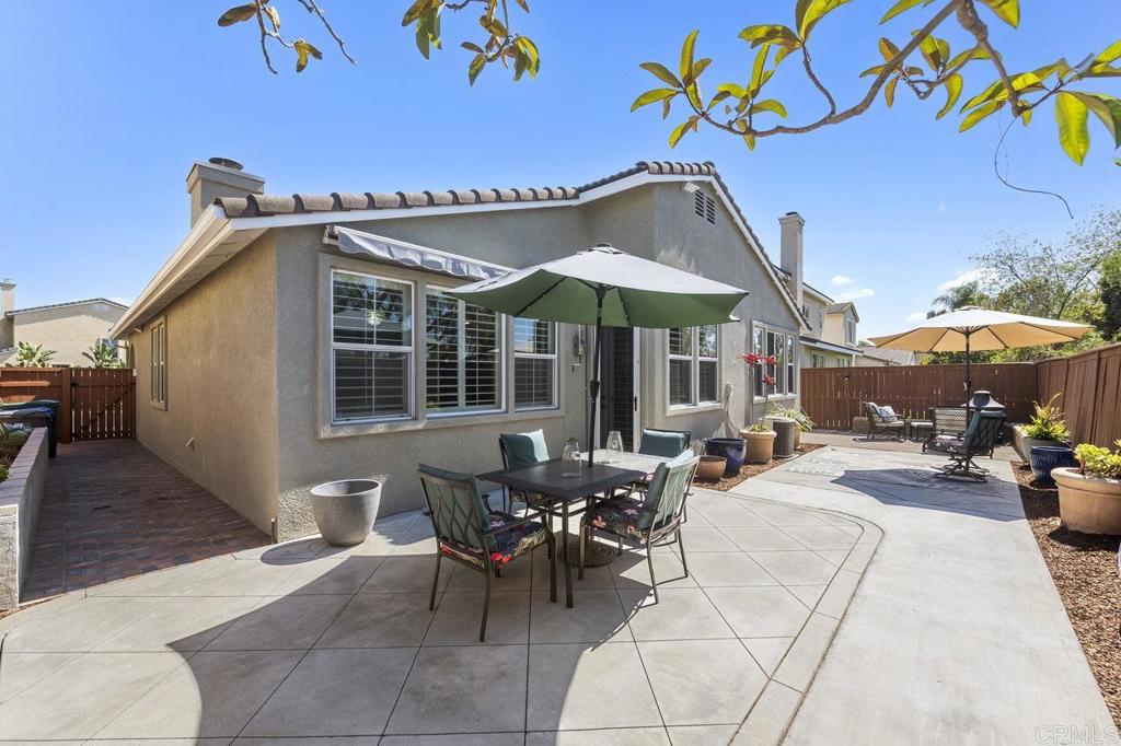 1113 Teal Way Oceanside, CA 92057 - Photo 3 of 49 a view of a patio with a table and chairs under an umbrella