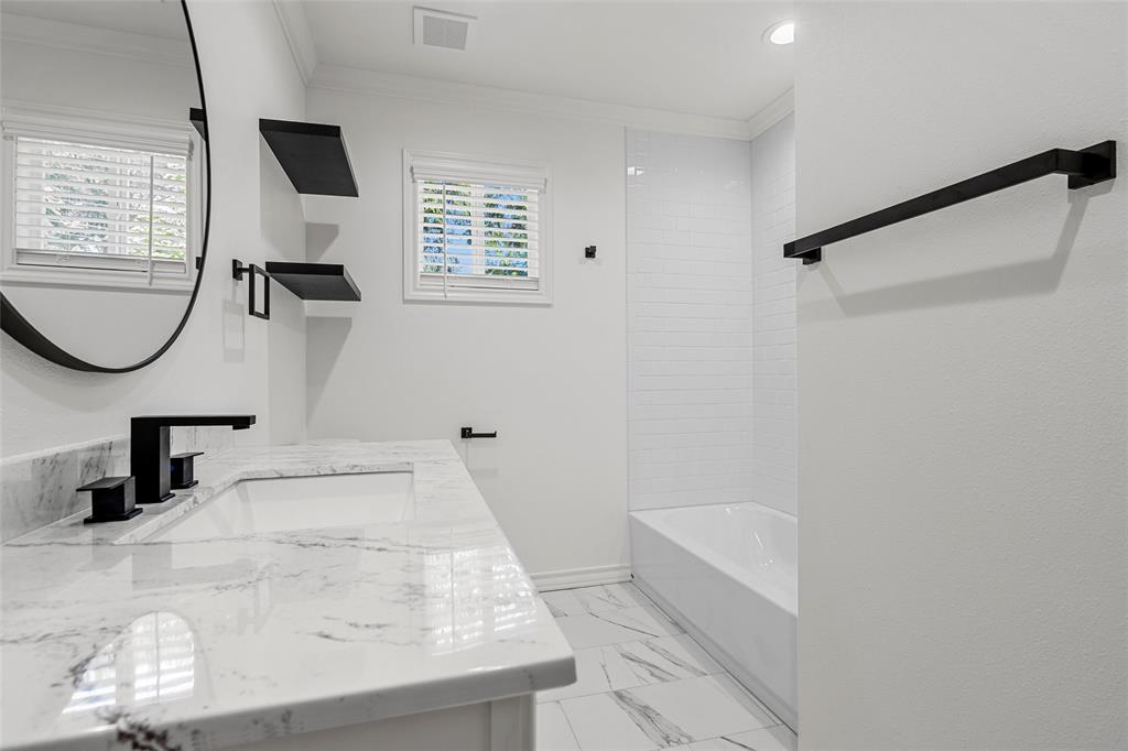 611 North Rita Street Lacy-Lakeview, TX 76705 - Photo 10 of 17 Bathroom with double vanity, crown molding, tub / shower combination, and light marble finish flooring