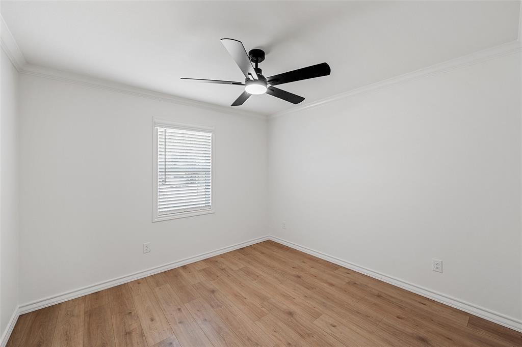 611 North Rita Street Lacy-Lakeview, TX 76705 - Photo 12 of 17 Empty room with light wood-style flooring, crown molding, and ceiling fan