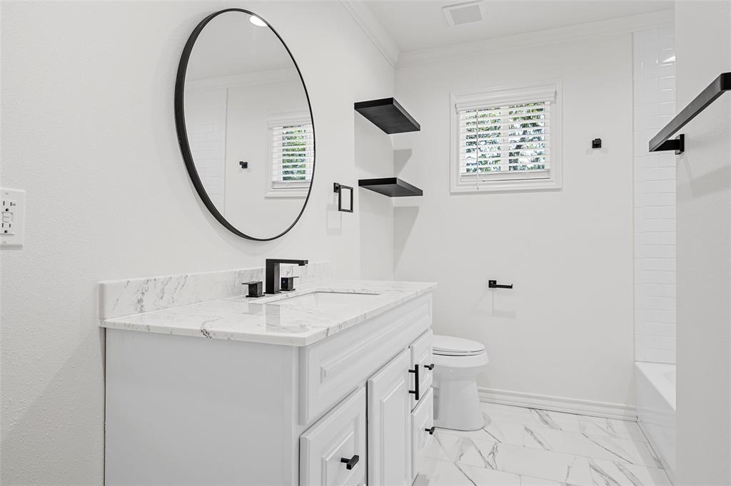 611 North Rita Street Lacy-Lakeview, TX 76705 - Photo 13 of 17 Full bathroom featuring vanity, healthy amount of natural light, ornamental molding, light marble finish flooring, and shower combination
