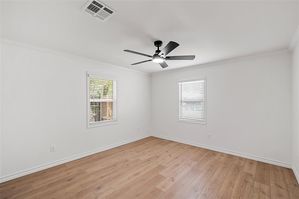 611 North Rita Street Lacy-Lakeview, TX 76705 - Photo 7 of 17 Spare room with crown molding, light wood-type flooring, and plenty of natural light