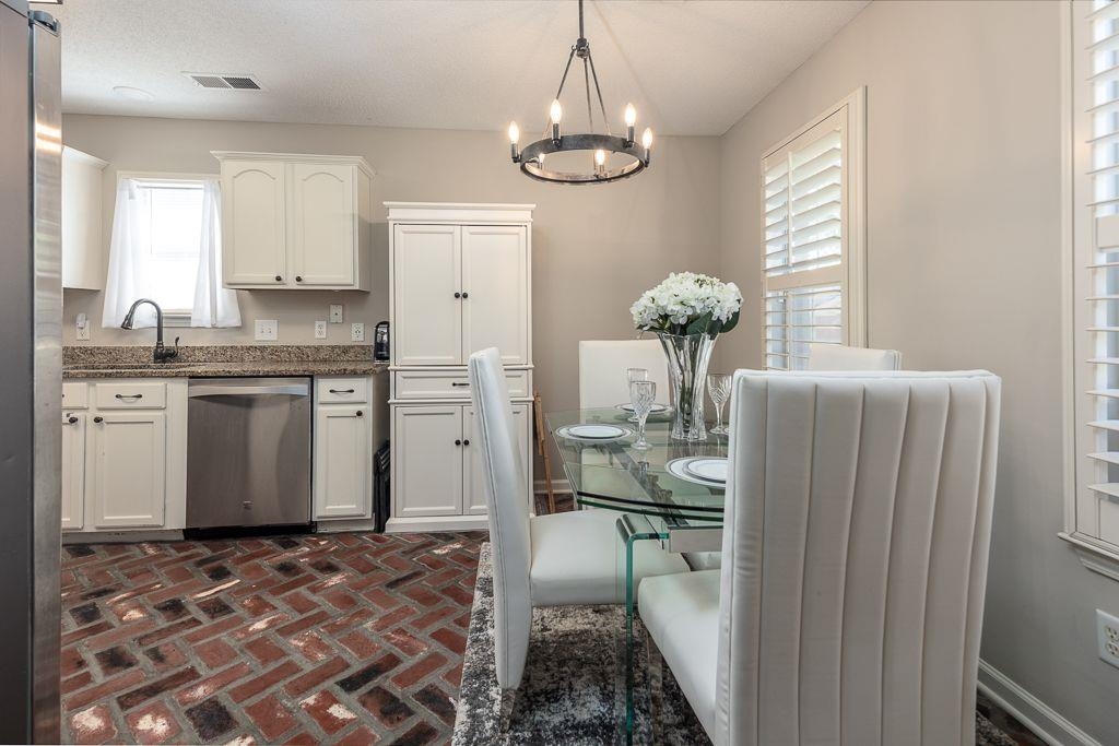 9768 Riggin Drive Memphis, TN 38002 - Photo 10 of 32 Kitchen and dining area featuring herringbone brick flooring