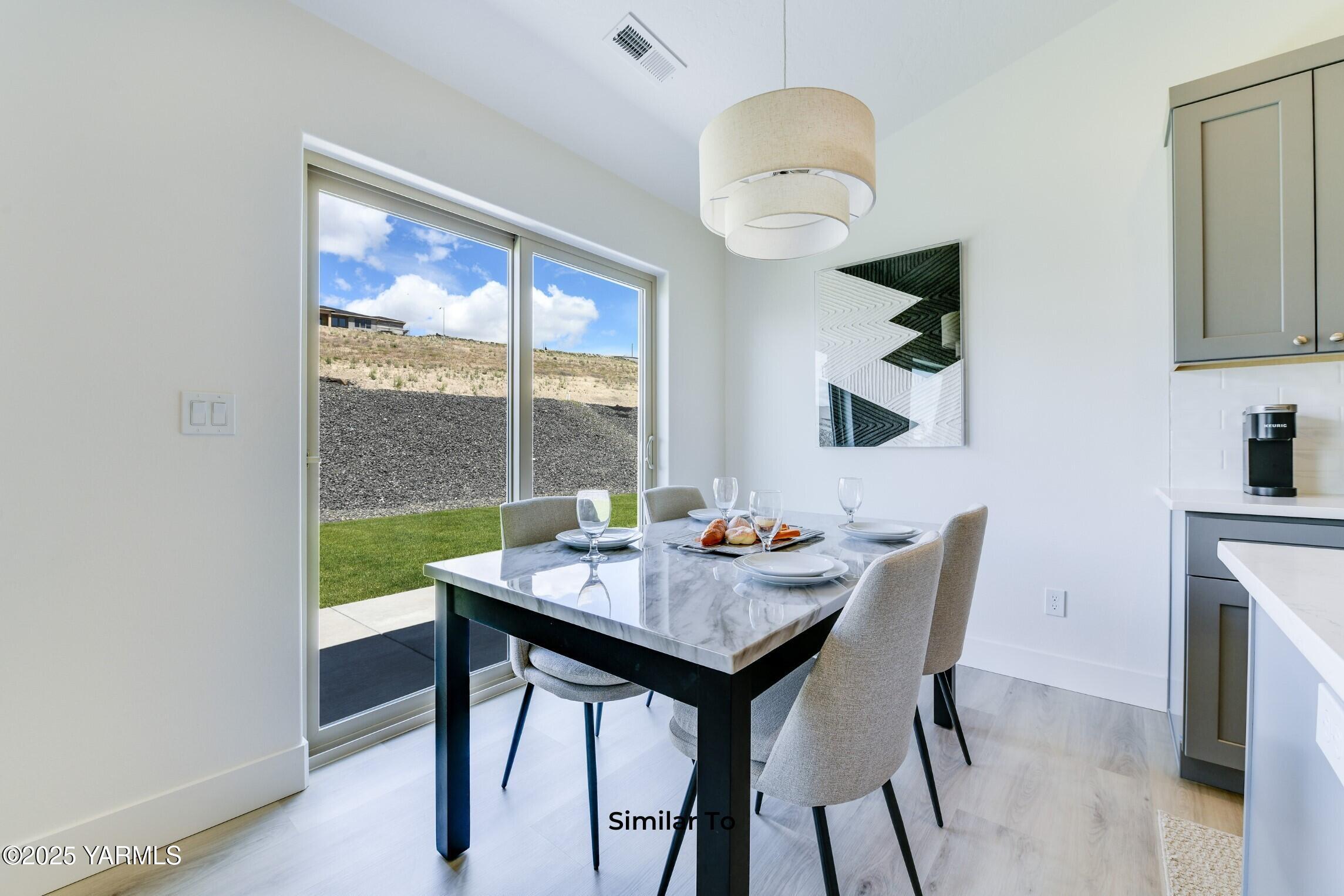 506 Grapevine Street, Unit PHASE 3 LOT 11) SPEC Grandview, WA 98930 - Photo 11 of 22 a view of a dining room with furniture window and outside view
