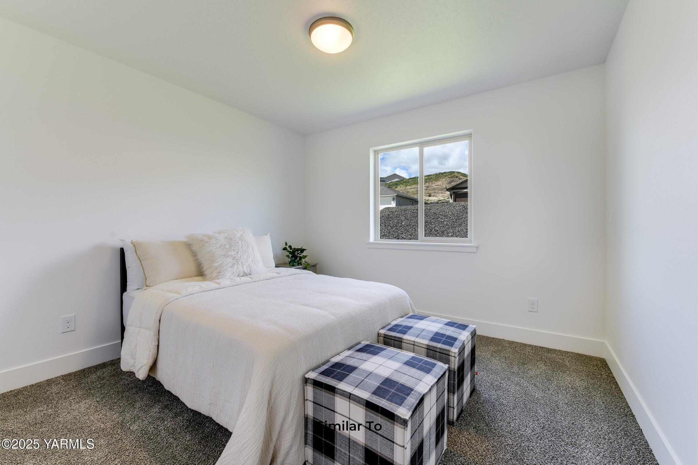 506 Grapevine Street, Unit PHASE 3 LOT 11) SPEC Grandview, WA 98930 - Photo 12 of 22 a bedroom with a bed and a window